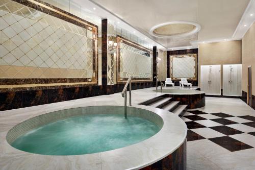 a bathroom with a jacuzzi tub in a room at Ramada by Wyndham Shymkent in Shymkent