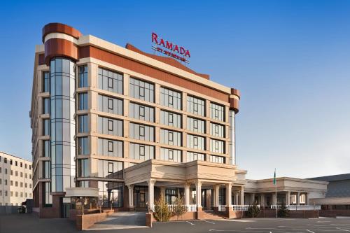 a rendering of a hotel building with a sign on it at Ramada by Wyndham Shymkent in Shymkent