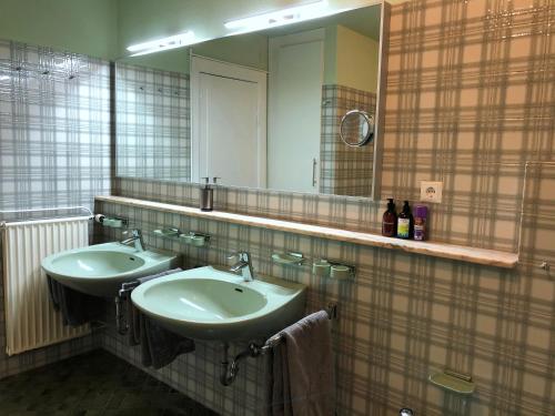 a bathroom with two sinks and a large mirror at INTERGO - Zimmer mit privatem Bad & Gemeinschaftsküche in Brackel