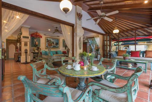 a living room with a table and chairs at Villa Kaja by Nagisa Bali in Seminyak