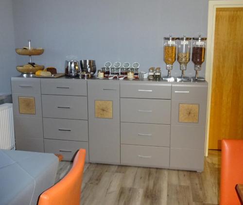 a kitchen with a counter with wine glasses on it at Haus Meeresblick in Heiligenhafen