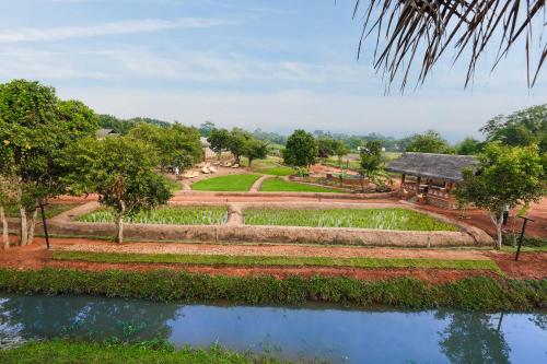 an image of a garden and a house at Ayurvie Sigiriya - Ayurvedic Retreat by Thema Collection in Sigiriya