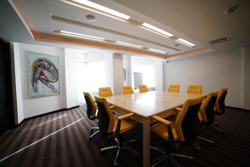 a conference room with a wooden table and chairs at Hotel Vojvodina in Zrenjanin