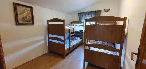 a room with three bunk beds in a room at Apartments Kolak in Rogoznica