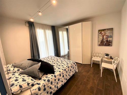 a bedroom with a bed and a table with a chair at La Terrazza sul Lago, Tignale in Tignale