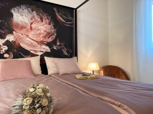 a bedroom with a bed with a painting on the wall at La Terrazza sul Lago, Tignale in Tignale