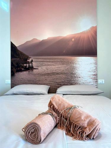 a bedroom with two beds with a view of a lake at La Terrazza sul Lago, Tignale in Tignale