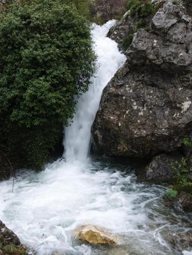 a river with white water rushing through a rock at CASA RURAL LLAVADOR Vall Guadalest in Benifató