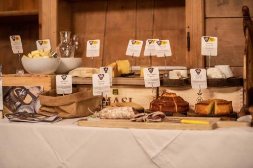 a table with different types of bread and pastries at Bivio Hotel Plaza in Livigno