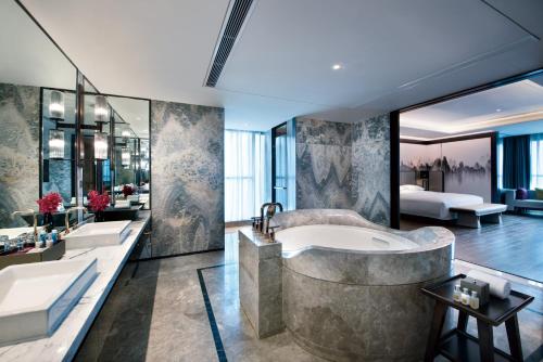 a bathroom with two sinks and a tub at Crowne Plaza Baoji City Center, an IHG Hotel in Baoji