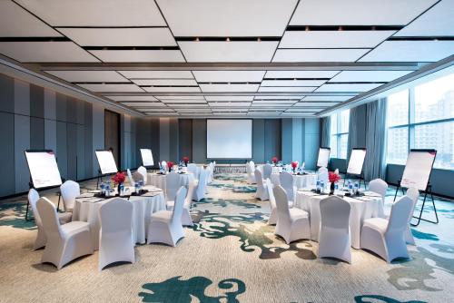 a conference room with white tables and white chairs at Crowne Plaza Baoji City Center by IHG in Baoji