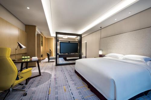 a hotel room with a large bed and a television at Crowne Plaza Baoji City Center by IHG in Baoji