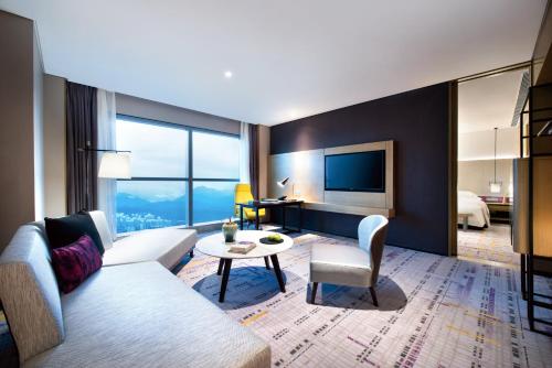 a living room with a couch and a table at Crowne Plaza Baoji City Center by IHG in Baoji