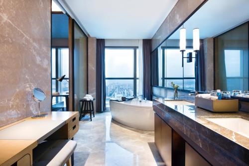 a bathroom with a tub and a large window at Crowne Plaza Baoji City Center by IHG in Baoji