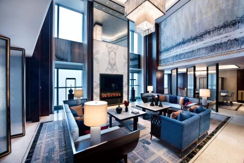 a living room with a couch and a fireplace at Crowne Plaza Baoji City Center by IHG in Baoji