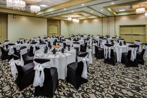 a banquet hall with tables and chairs in a room at Crowne Plaza Phoenix Airport - PHX by IHG in Phoenix