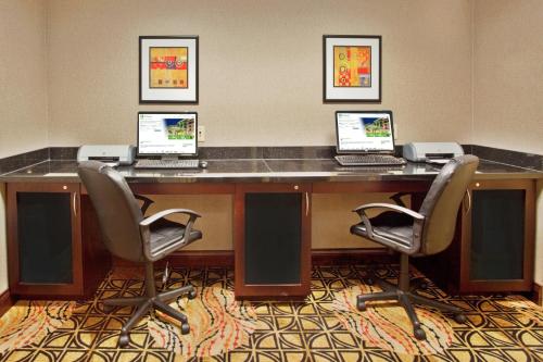 a conference room with three computers on a desk at Holiday Inn Express Hotel & Suites Atlanta-Cumming by IHG in Cumming