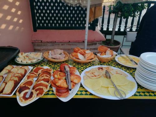a table with plates of food on top at Riad petit Karmela in Marrakech
