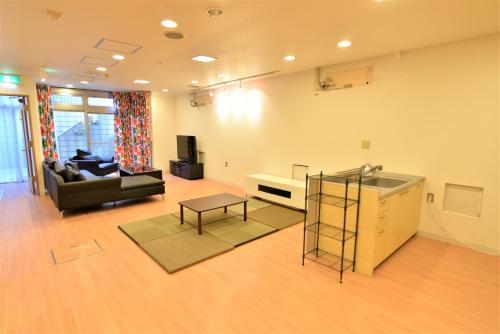 a large living room with a couch and a sink at Syukur Ofuna in Kamakura