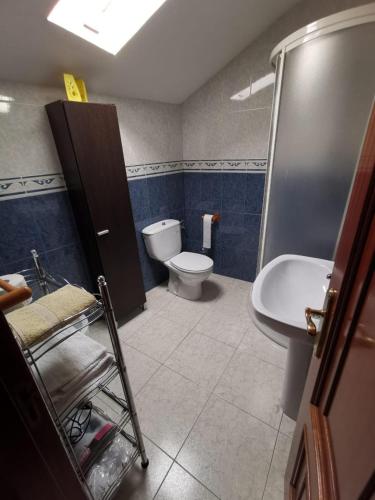 a bathroom with a toilet and a sink at Casa Foz in Foz