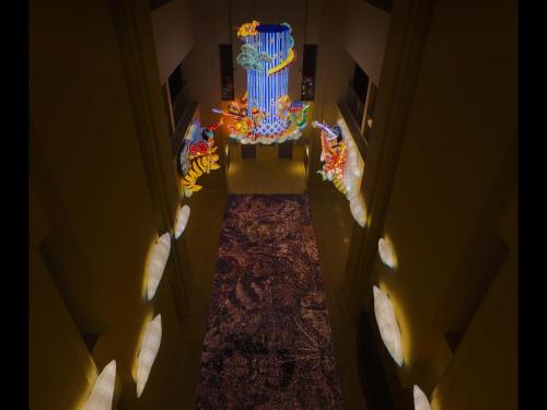 an overhead view of a room with a large cake at ART HOTEL Aomori in Aomori