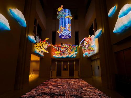 a hallway with colorful chandeliers in a building at ART HOTEL Aomori in Aomori