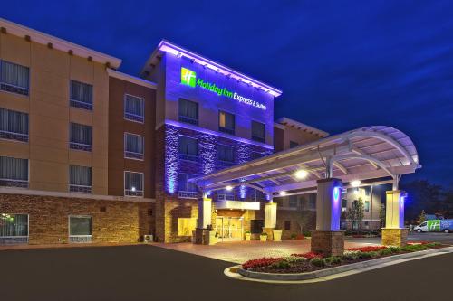 a hotel with a lit up sign in front of it at Holiday Inn Express Hotel & Suites Ann Arbor West by IHG in Ann Arbor