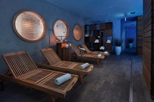a living room with three chairs and circular mirrors at Spa Hotel Felicitas in Poděbrady