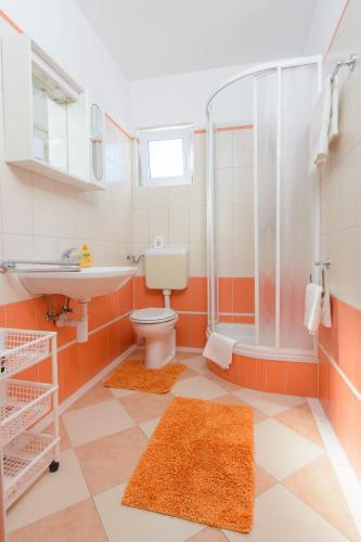 a bathroom with a toilet and a sink and a shower at Apartments Anton in Vinišće
