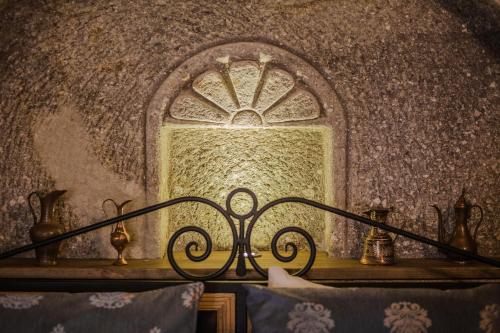 a bedroom with a window in a wall at Lunar Cappadocia Hotel in Goreme