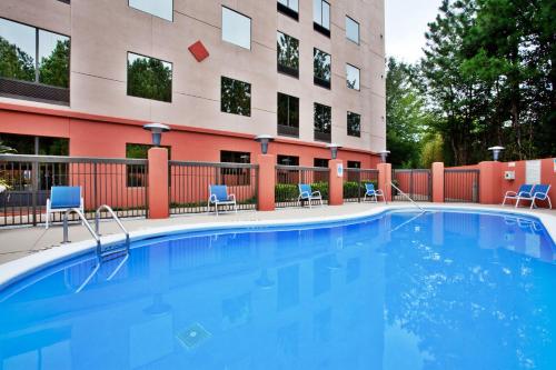 a large swimming pool in front of a building at Holiday Inn Express Hotel & Suites Lawrenceville by IHG in Lawrenceville