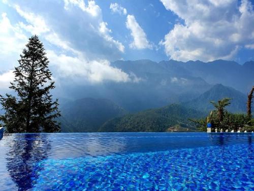 a swimming pool with a view of the mountains at Catcat Garden House in Sa Pa