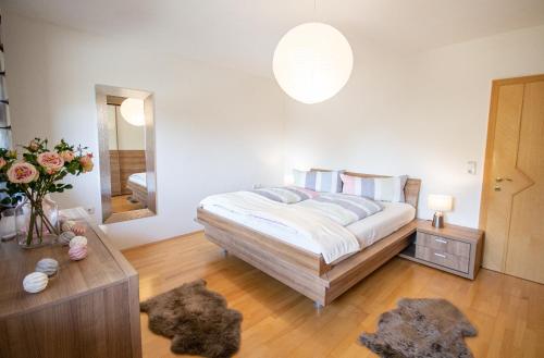 a bedroom with a bed and a large mirror at Ferienwohnung Kienast in Pfons