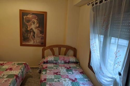 a bedroom with a bed and a window at Casa Rural Adriana, Montanejos in Montanejos