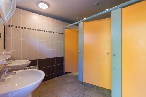 a bathroom with two sinks and two stalls at Village de Yourtes in Beaussais sur Mer