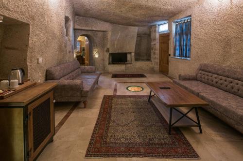 a living room with a couch and a table at Lunar Cappadocia Hotel in Goreme