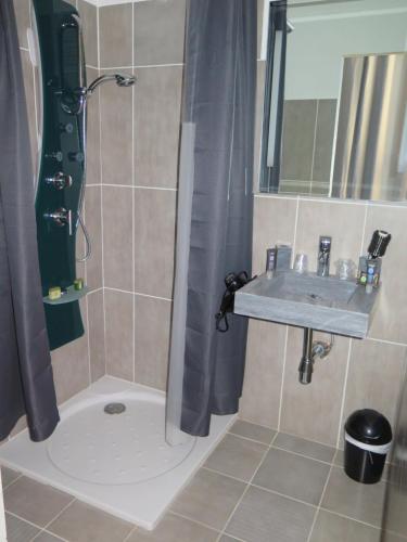 a bathroom with a sink and a shower at Villa fiora chambre in Martigues