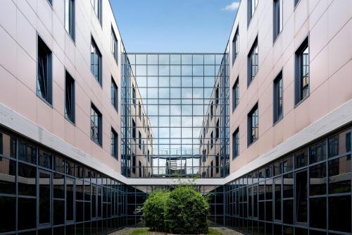 an external view of a building with glass windows at Best Western Cavalieri Della Corona in Cardano al Campo