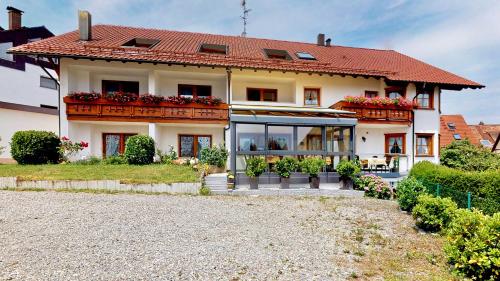 a large white house with a red roof at Hotel Haus Seehang in Konstanz