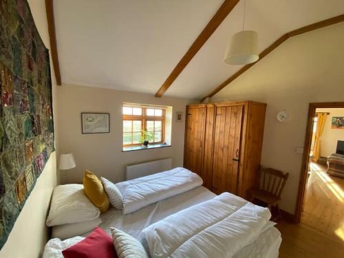 a room with two beds and a couch in it at Sundance Cottage Sleeps 4 plus 2 in Camelford