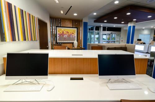 two computers sitting on a desk in an office at Holiday Inn Express & Suites Taylor by IHG in Taylor