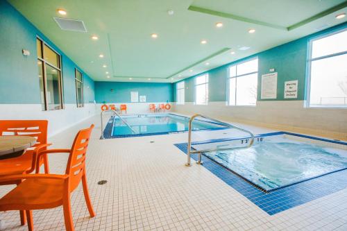 a large swimming pool with a hot tub at Candlewood Suites West Edmonton - Mall Area by IHG in Edmonton