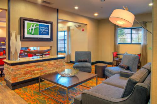 a living room with a tv and a couch and a table at Holiday Inn Express and Suites Granbury by IHG in Granbury