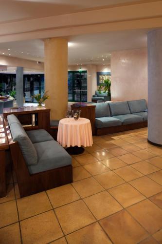 a lobby with couches and a table in a building at Hotel Diana in Valdobbiadene