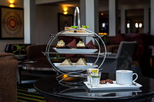 a tray of pastries on a table with a cup of coffee at Earl's Reef in Bentota