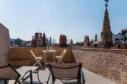 a patio with chairs and a table on a brick wall at Ramblas Hotel in Barcelona