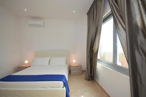 a bedroom with a bed and a large window at da Rocco B&B in Sant'Isidoro