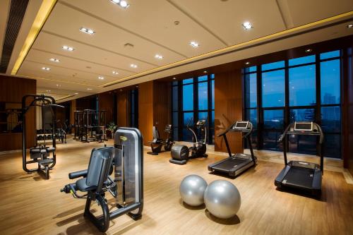 a gym with treadmills and exercise equipment in a building at Crowne Plaza Hefei Rongqiao by IHG in Hefei