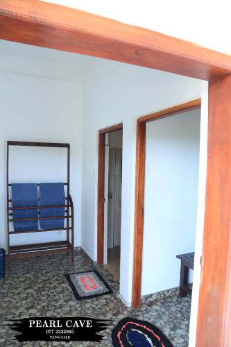 a room with a mirror and a bed in a room at Pearl Cave Cabanas & Resturant in Tangalle