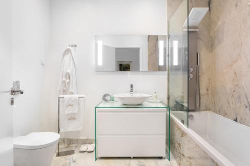 リスボンにあるChiado Apartments by Courtesy Morningのバスルーム(洗面台、トイレ、バスタブ付)